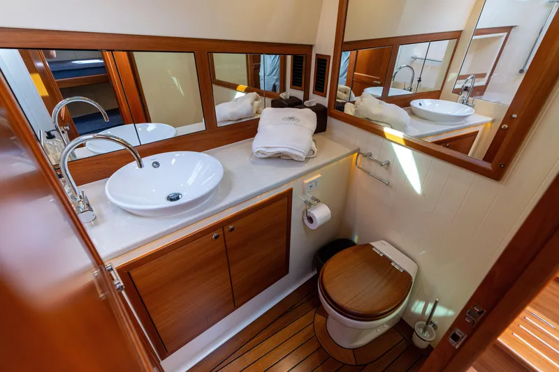 Slide: The Image of Luxurious 2016 Palm Beach Motor Yachts PB50 bathroom with elegant wood finishes and modern fixtures. - 60