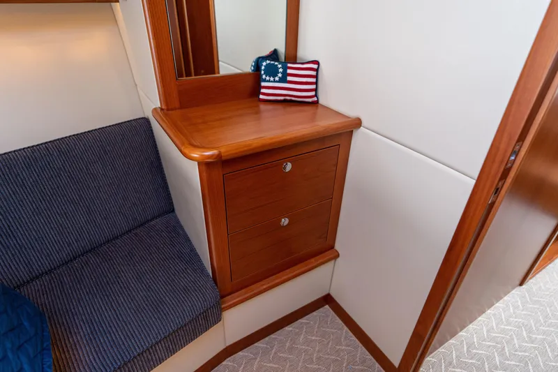 Slide: The Image of 2016 Palm Beach Motor Yachts PB50 interior with wooden cabinetry and American flag decor. - 67