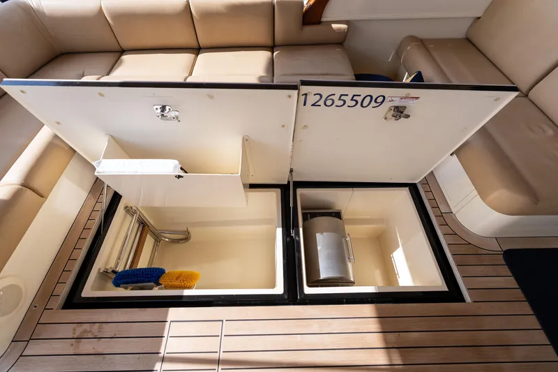Slide: The Image of 2016 Palm Beach Motor Yachts PB50 storage compartments with cleaning brushes and equipment. - 68