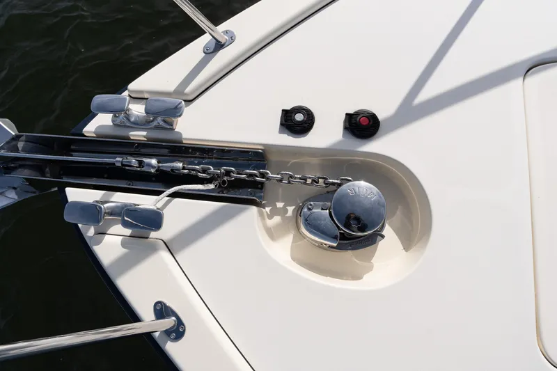 Slide: The Image of 2016 Palm Beach Motor Yachts PB50 on water, marina in background, clear sky. - 28