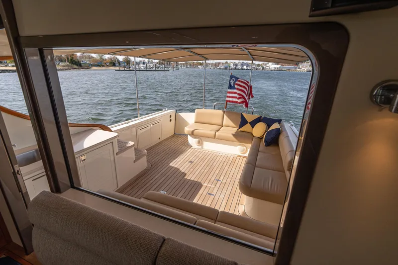 Slide: The Image of 2016 Palm Beach Motor Yachts PB50 interior with open fridge and storage on deck. - 35