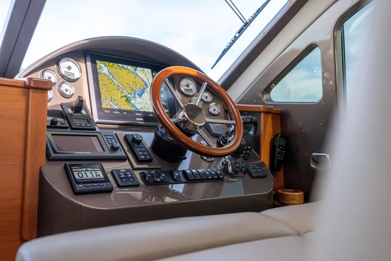 Slide: The Image of 2016 Palm Beach Motor Yachts PB50 interior with wooden helm and ocean view. - 43