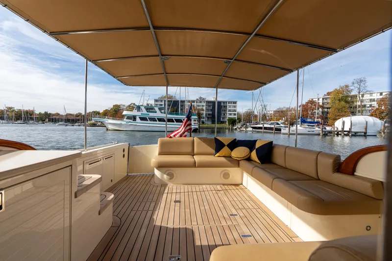 Slide: The Image of 2016 Palm Beach Motor Yachts PB50 interior with seating, sink, and water view. - 5