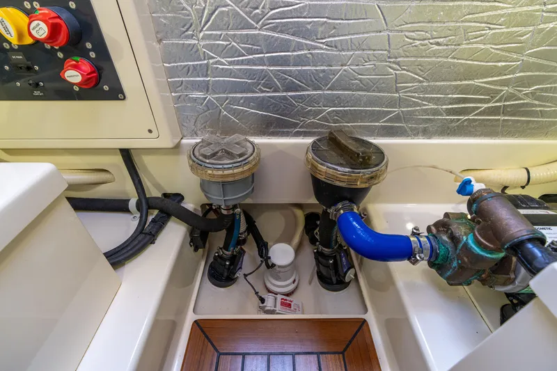 Slide: The Image of Engine room of 2016 Palm Beach Motor Yachts PB50, featuring mechanical components and safety labels. - 52