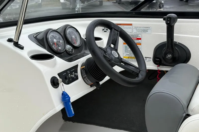 Slide: The Image of 2022 Bayliner 170 Bowrider dashboard with steering wheel and control panel. - 10