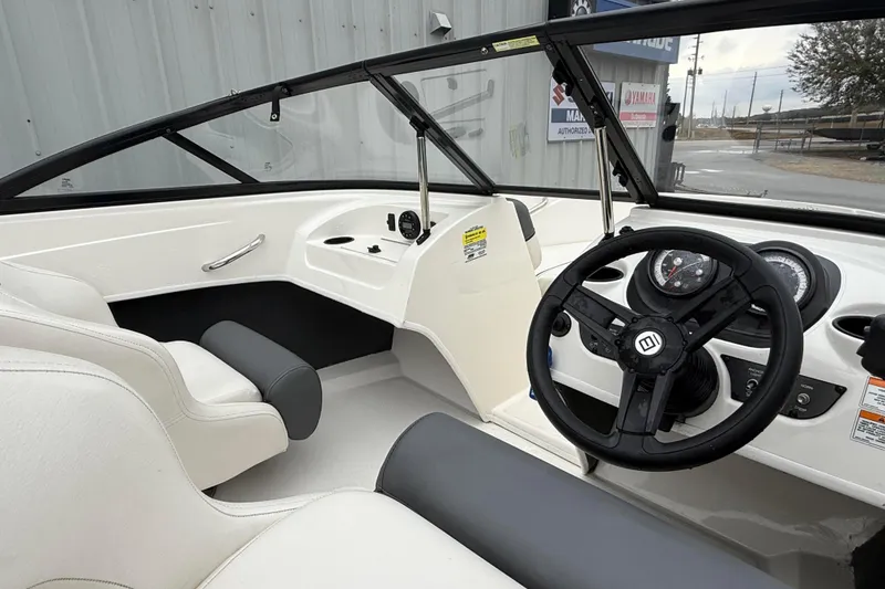 Slide: The Image of 2022 Bayliner 170 Bowrider interior with steering wheel and dashboard controls. - 11