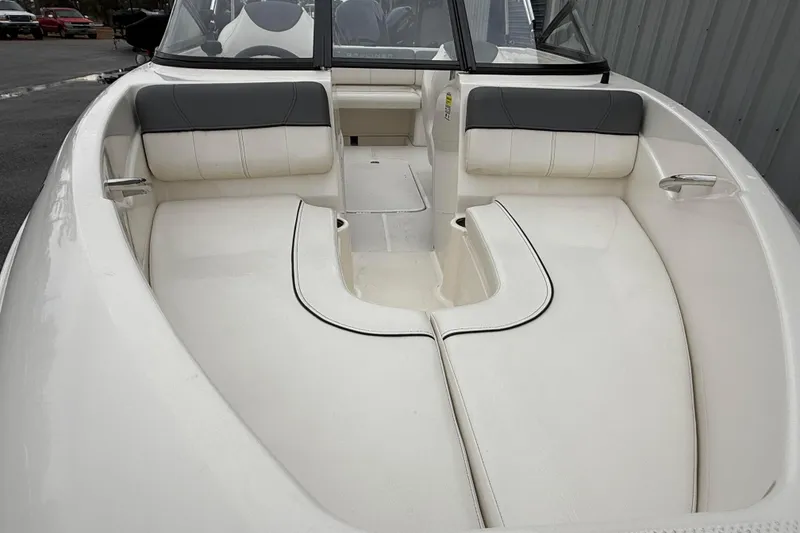 Slide: The Image of 2022 Bayliner 170 Bowrider interior with white seating and black accents. - 4