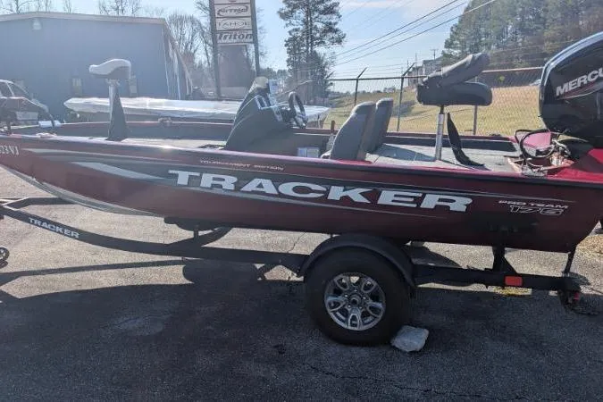 Slide: The Image of 2025 Tracker Pro Team 175 TXW Tournament Edition boat on trailer, parked outdoors. - 6