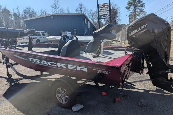 Slide: The Image of 2025 Tracker Pro Team 175 TXW Tournament Edition boat with Mercury engine, parked outdoors. - 7