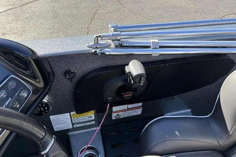 Slide: The Image of 2019 Nitro ZV19 boat interior with steering wheel, controls, and fishing rod holders. - 25