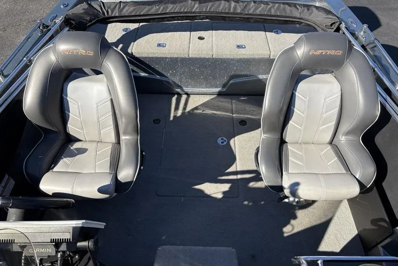Slide: The Image of 2019 Nitro ZV19 boat interior with two gray seats and Garmin equipment. - 27