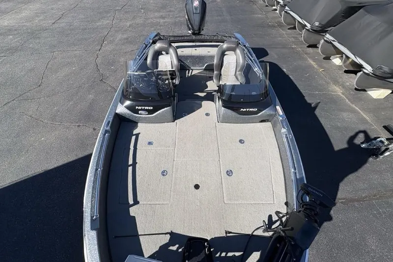 Slide: The Image of 2019 Nitro ZV19 boat with dual seats and spacious deck, parked on asphalt. - 31