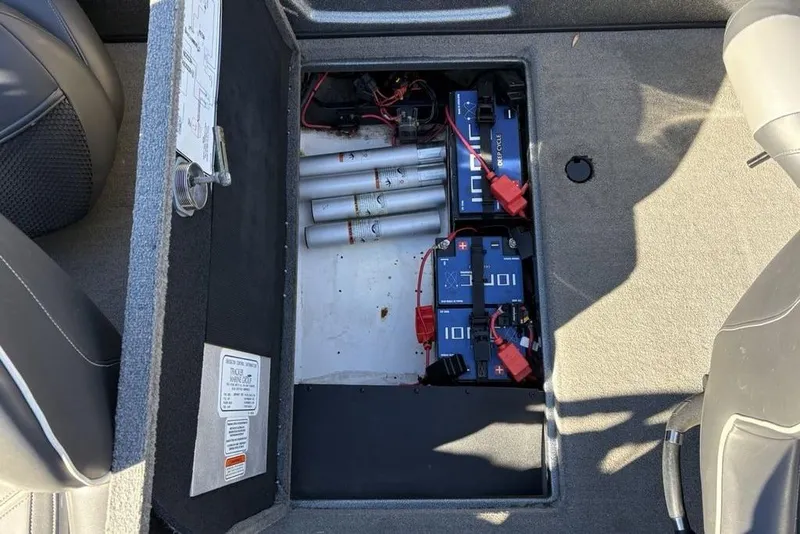 Slide: The Image of 2019 Nitro ZV19 boat battery compartment with wiring and storage space. - 32