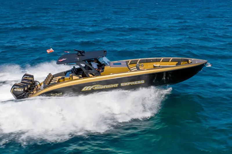 The Image of 2023 Midnight Express 43 Open speedboat cruising on blue ocean waters. - 0