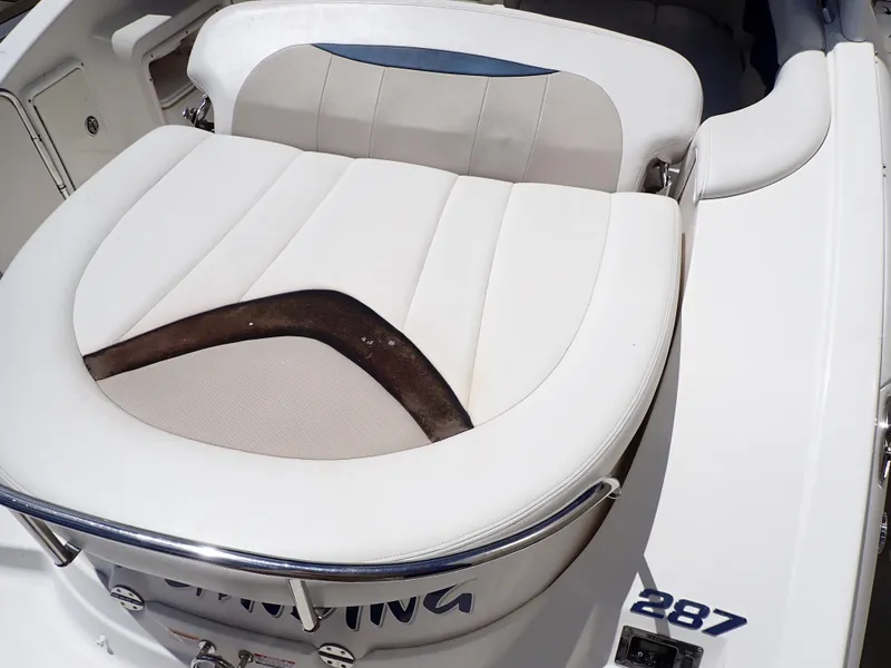 Slide: The Image of 2011 Chaparral 287 SSX boat seat with white and beige upholstery. - 11
