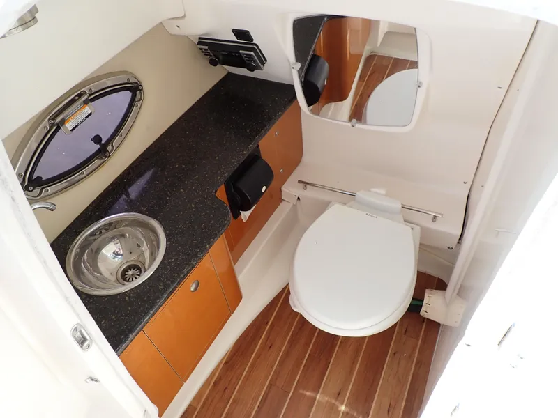 Slide: The Image of 2011 Chaparral 287 SSX boat bathroom with sink, toilet, and wooden flooring. - 13