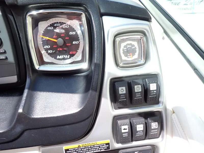 Slide: The Image of Dashboard of 2011 Chaparral 287 SSX boat with speedometer and control switches. - 15