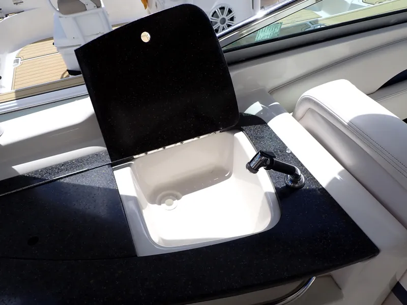 Slide: The Image of Chaparral 287 SSX 2011 boat sink with black countertop and faucet. - 21
