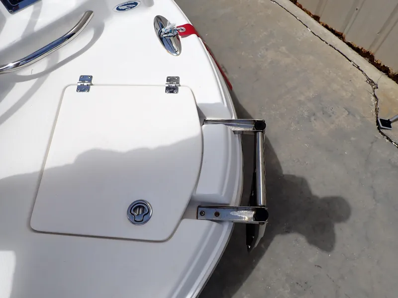 Slide: The Image of 2011 Chaparral 287 SSX boat with swim platform and ladder on concrete surface. - 22