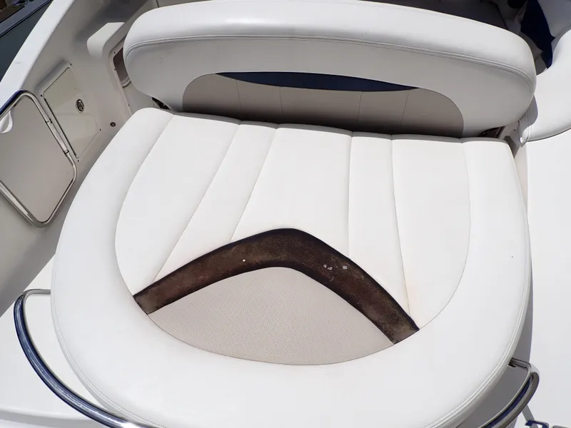 Slide: The Image of White leather seat on 2011 Chaparral 287 SSX boat, showing wear and discoloration. - 24