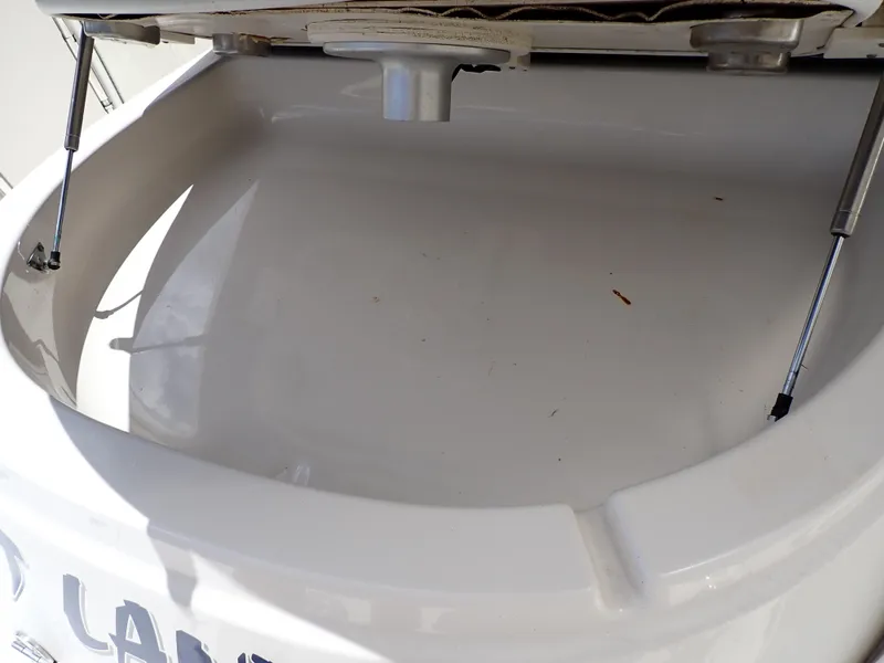 Slide: The Image of Open storage compartment of 2011 Chaparral 287 SSX boat with hydraulic supports. - 25