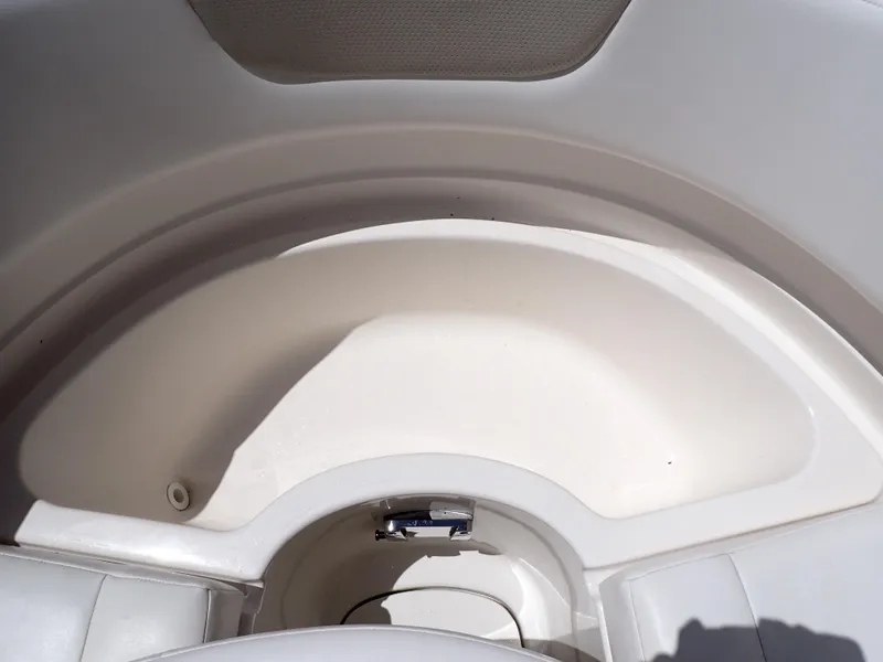Slide: The Image of 2011 Chaparral 287 SSX boat interior storage compartment, white and spacious design. - 30