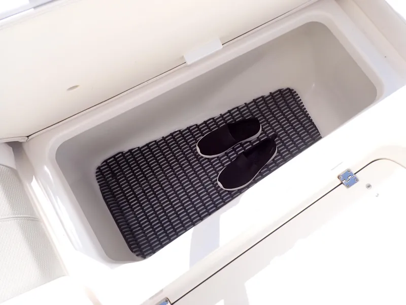 Slide: The Image of Storage compartment in 2011 Chaparral 287 SSX boat with mat and shoes inside. - 32