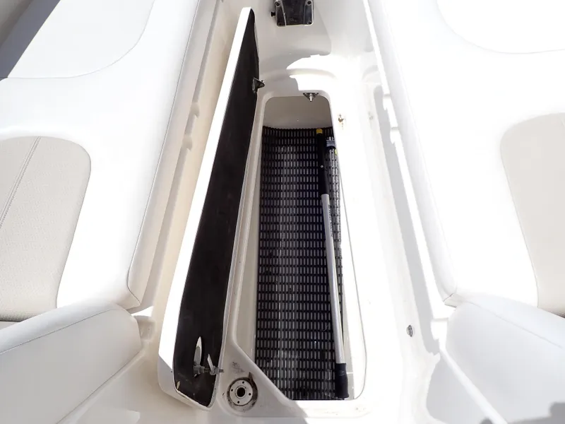 Slide: The Image of Open storage compartment on 2011 Chaparral 287 SSX boat, featuring white interior design. - 36
