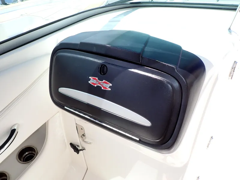 Slide: The Image of 2011 Chaparral 287 SSX boat dashboard with storage compartment and logo. - 42