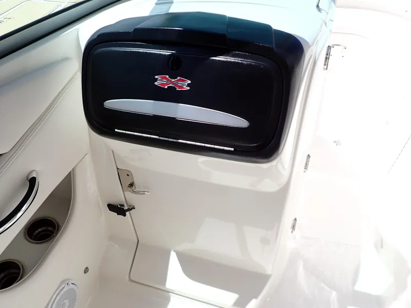 Slide: The Image of 2011 Chaparral 287 SSX boat interior with storage compartment and cup holders. - 44