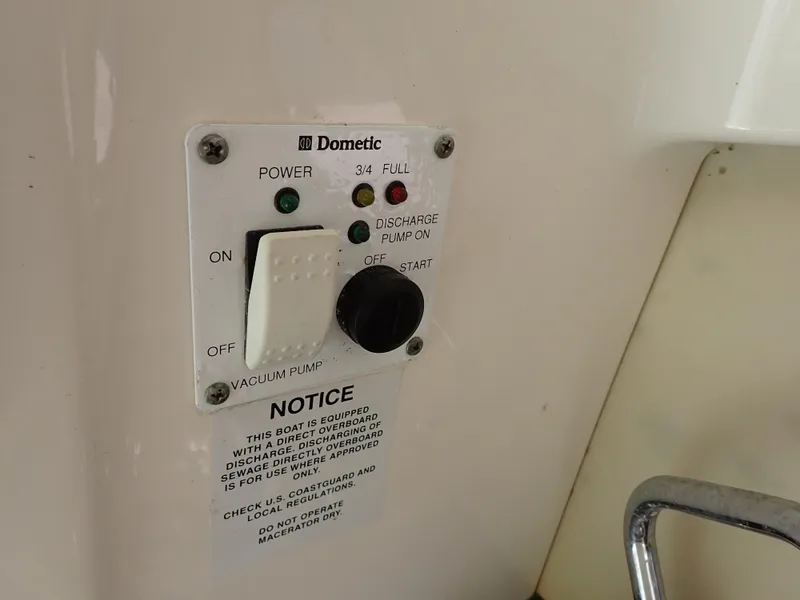 Slide: The Image of Control panel for Dometic vacuum pump on 2011 Chaparral 287 SSX boat. - 49