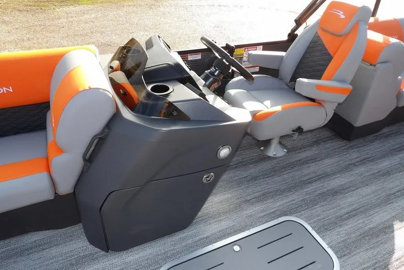Slide: The Image of 2026 Bennington 22 SSR boat interior with orange and gray seating and modern console. - 14
