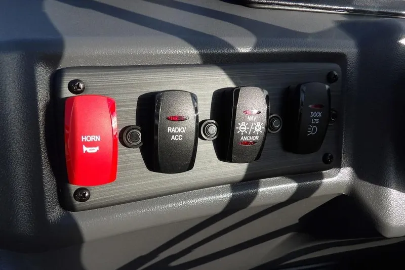 Slide: The Image of Control panel of 2026 Bennington 22 SSR boat with horn, radio, and light switches. - 22