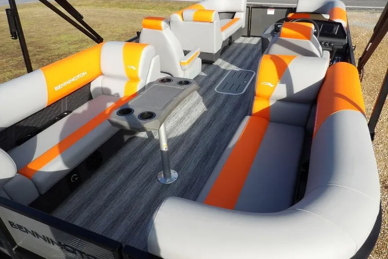 Slide: The Image of 2026 Bennington 22 SSR pontoon boat interior with orange and gray seating and table. - 28