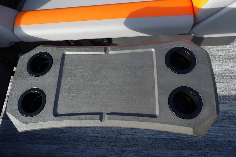 Slide: The Image of 2026 Bennington 22 SSR boat table with four cup holders and orange seat detail. - 29