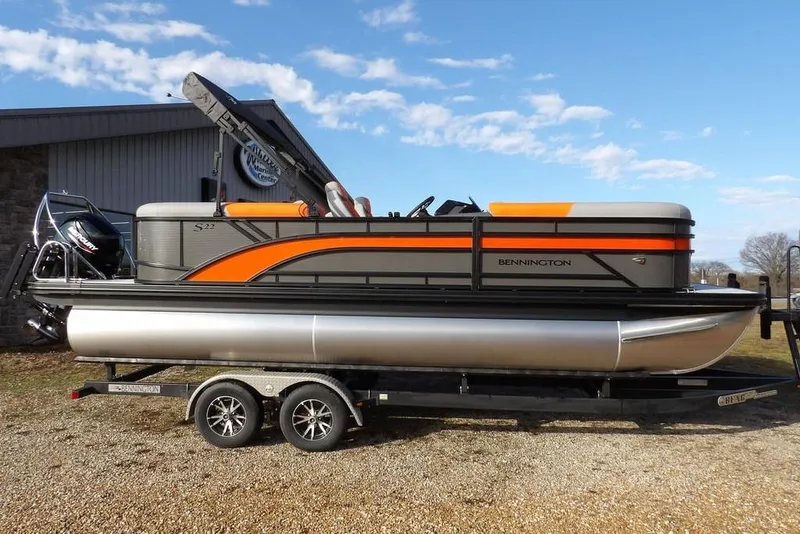 Slide: The Image of 2026 Bennington 22 SSR pontoon boat on trailer, featuring sleek design and vibrant orange accents. - 3