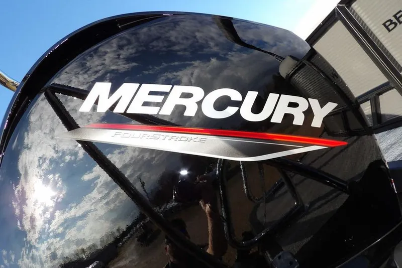 Slide: The Image of Mercury FourStroke engine on 2026 Bennington 22 SSR boat, reflecting sky and clouds. - 35