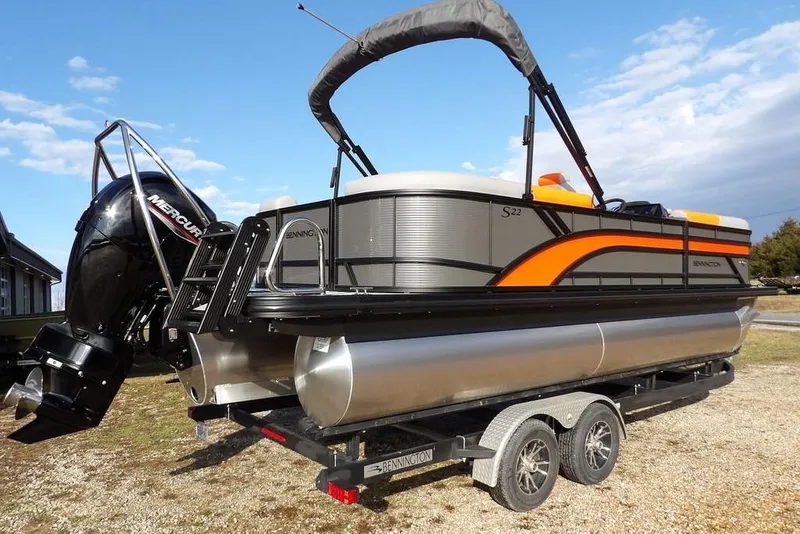 Slide: The Image of 2026 Bennington 22 SSR pontoon boat with Mercury engine on trailer, featuring sleek design. - 7