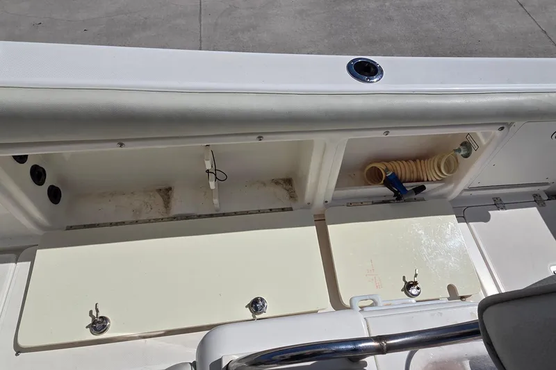 Slide: The Image of 2006 Century 2900 Center Console boat storage compartments and hose setup. - 11