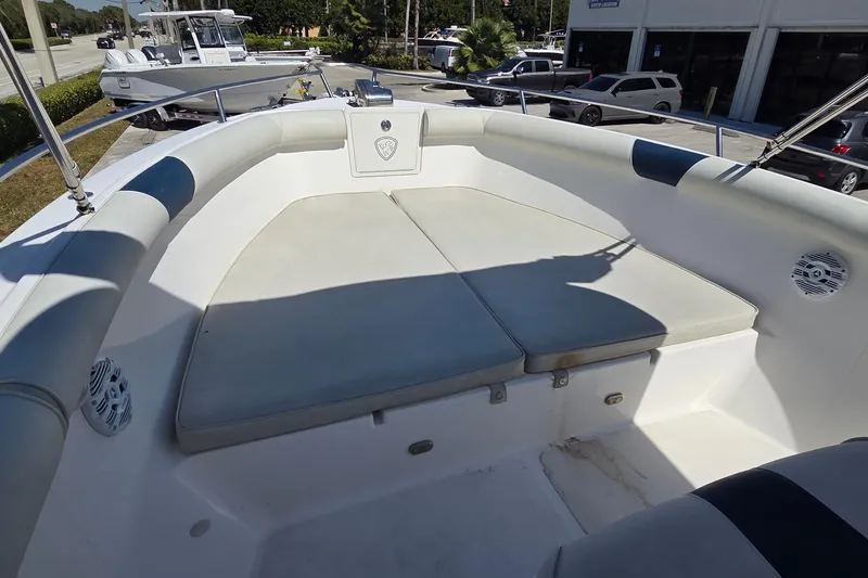 Slide: The Image of 2006 Century 2900 Center Console boat with cushioned seating area, parked outdoors. - 15