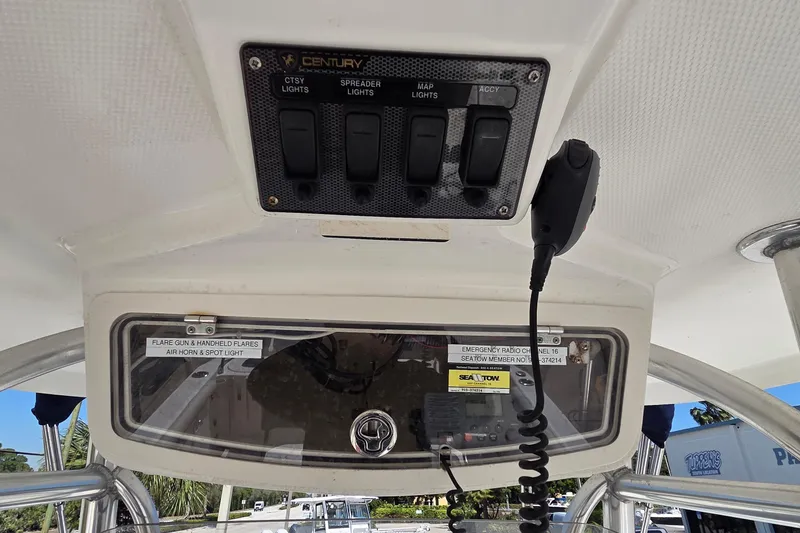 Slide: The Image of 2006 Century 2900 Center Console boat dashboard with control panel and radio. - 18