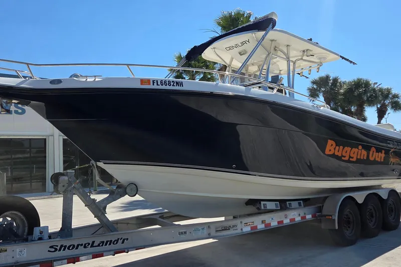 Slide: The Image of 2006 Century 2900 Center Console boat on trailer, labeled "Buggin Out." - 2