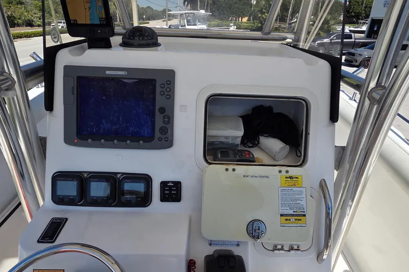 Slide: The Image of Center console of a 2006 Century 2900 boat with navigation equipment and storage compartment. - 21
