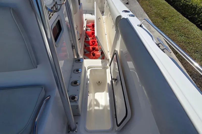 Slide: The Image of 2006 Century 2900 Center Console boat with open storage compartments and life jackets. - 22