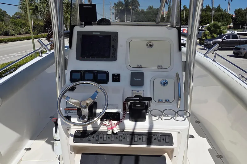Slide: The Image of Century 2900 Center Console 2006 boat dashboard with steering wheel and navigation equipment. - 24