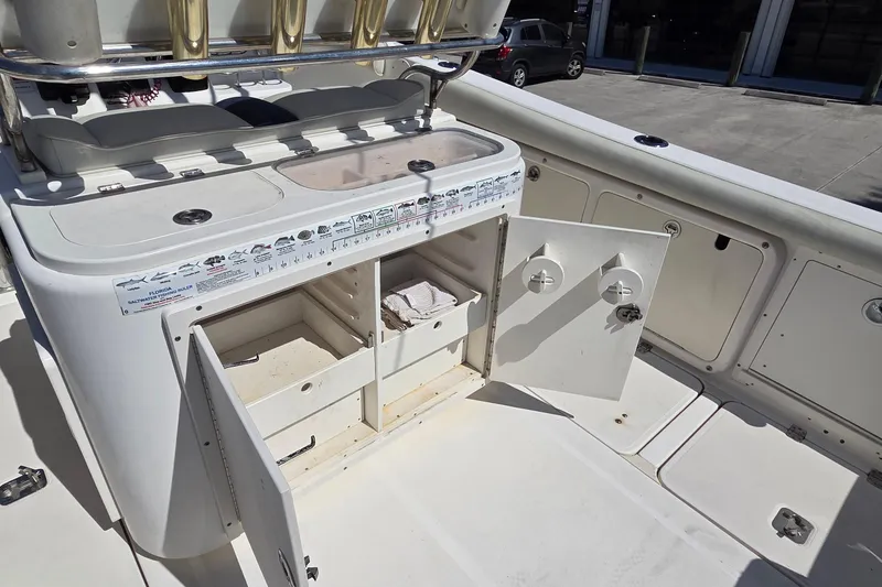 Slide: The Image of 2006 Century 2900 Center Console boat with open storage compartments and fishing gear setup. - 7
