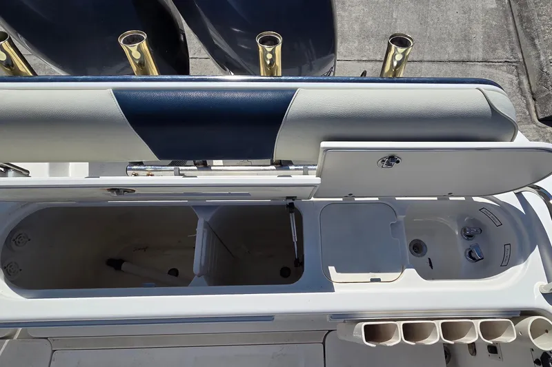 Slide: The Image of 2006 Century 2900 Center Console boat interior with storage compartments and rod holders. - 8