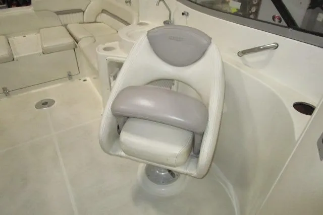 Slide: The Image of 2004 Stingray 240 LR boat interior with swivel captain's chair and seating area. - 13