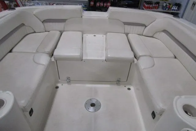 Slide: The Image of 2004 Stingray 240 LR boat interior with white cushioned seating arrangement. - 15