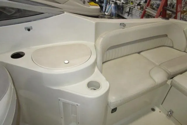 Slide: The Image of 2004 Stingray 240 LR boat interior with seating and storage compartments. - 17